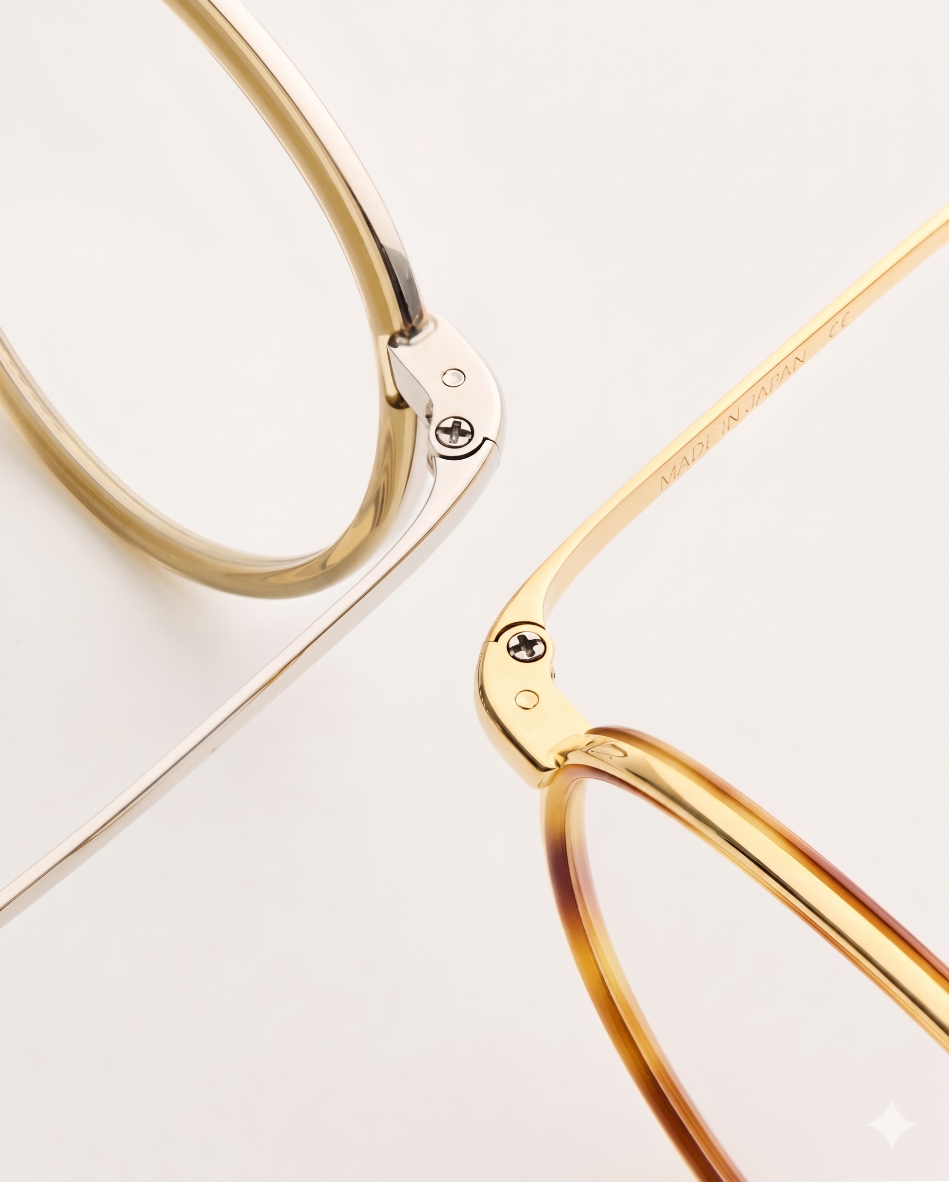 Two frames crossing diagonally, silver and gold finishes