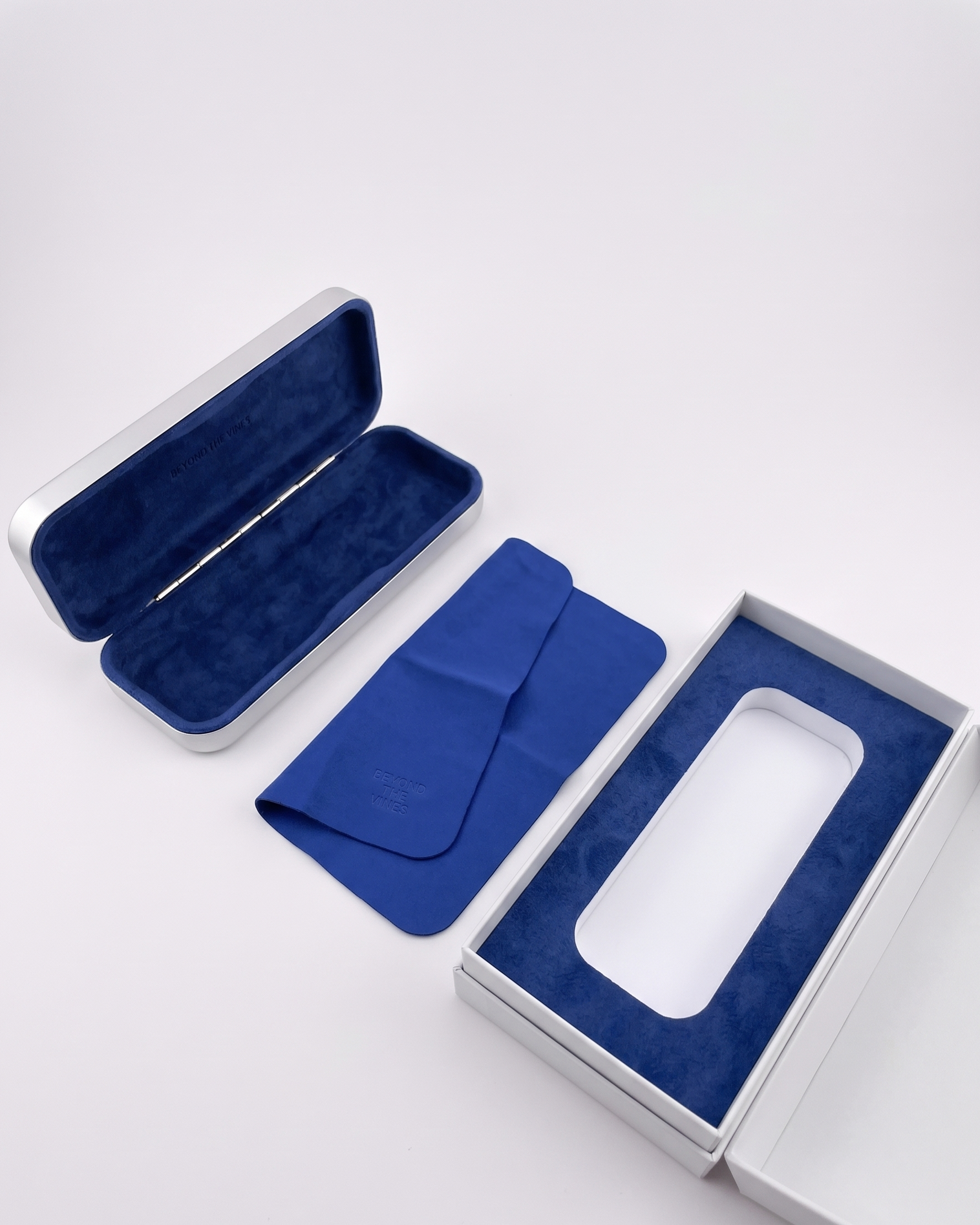 Beyond the Vines packaging system: brushed aluminium case, blue velvet cloth, and presentation box.